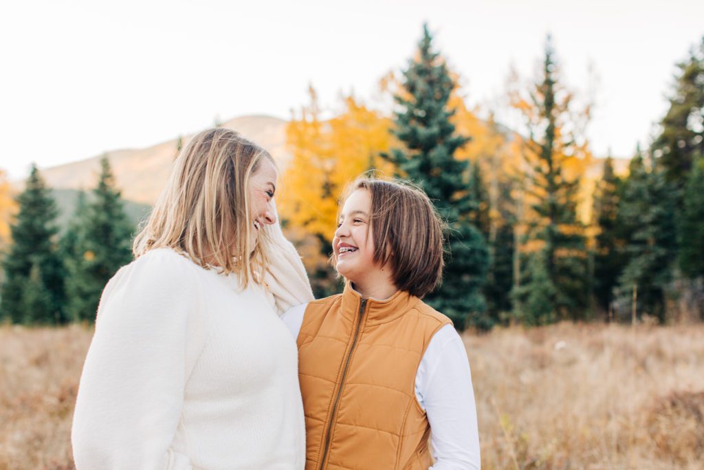 mom and daughter laugh during their family photos