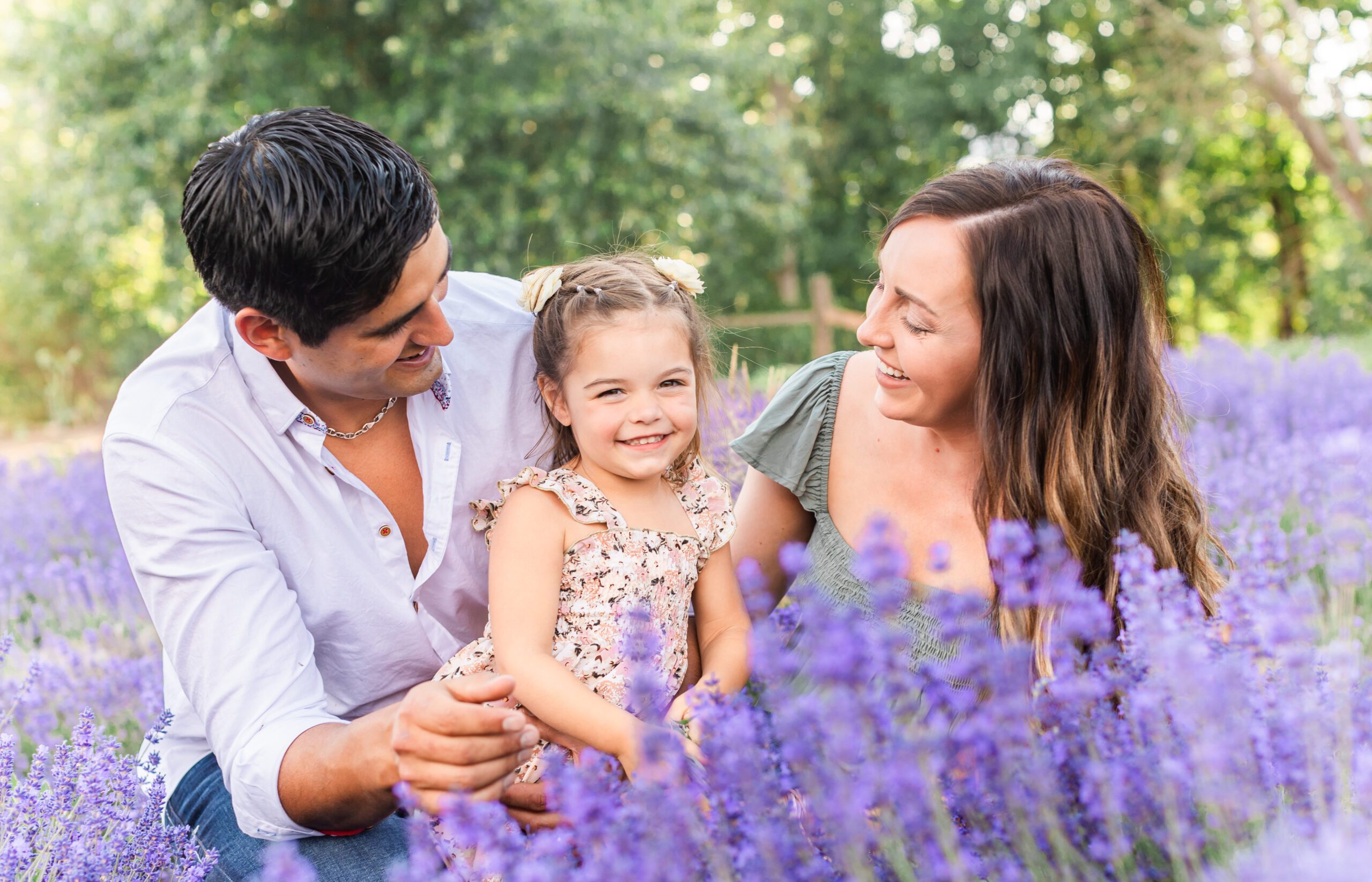 family in a lavender field smiling for famaily photos