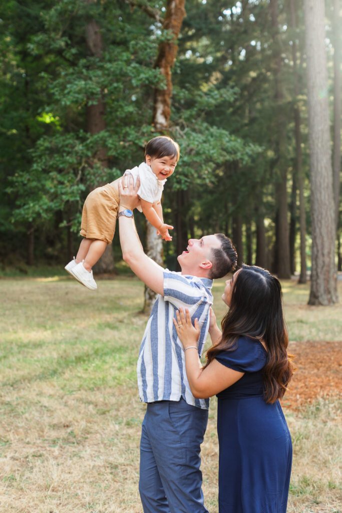 candid photo of little boy being thrown in the air during roseburg family photos
