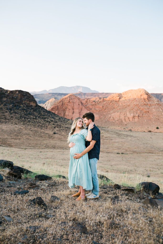 Maternity photos in St. George Utah with the red rocks and lava rocks