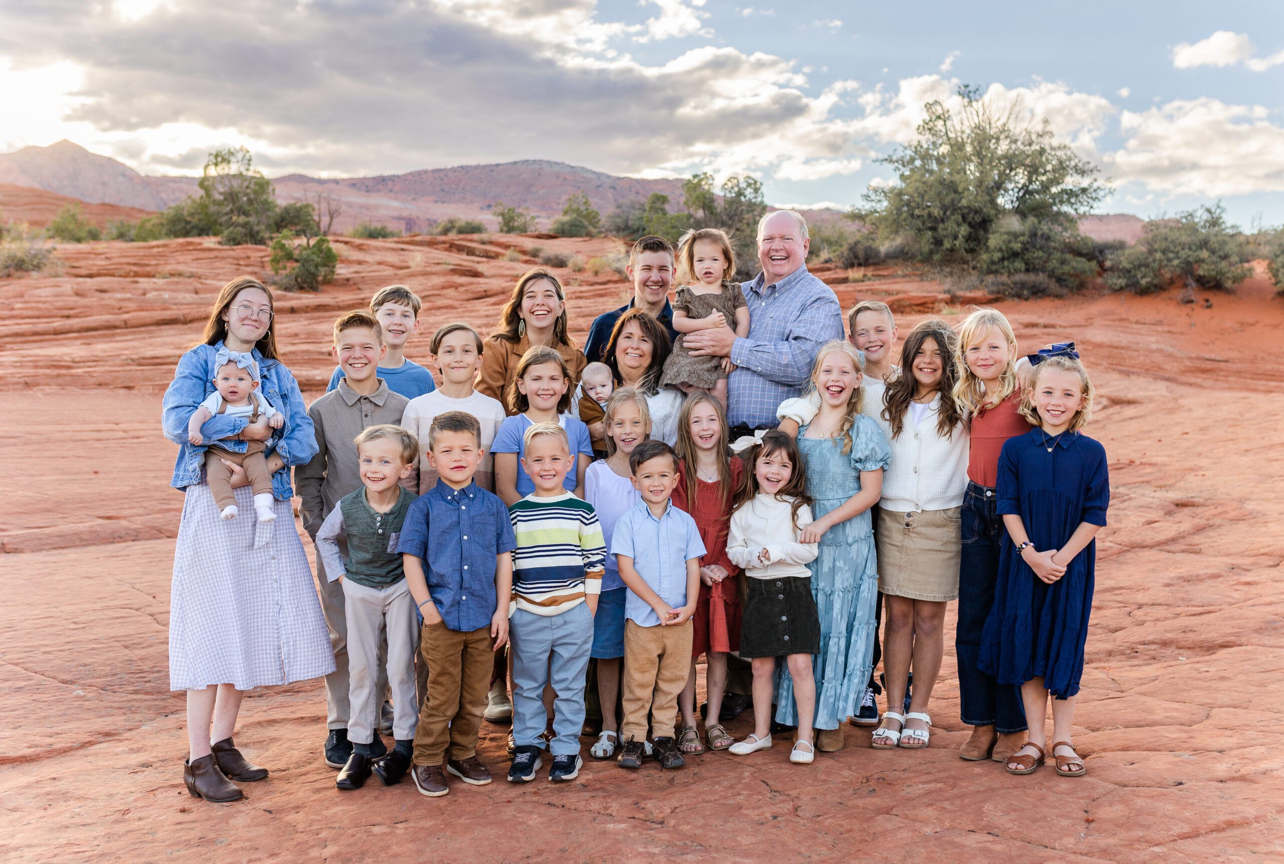 extended family smiling for photos with grandparents